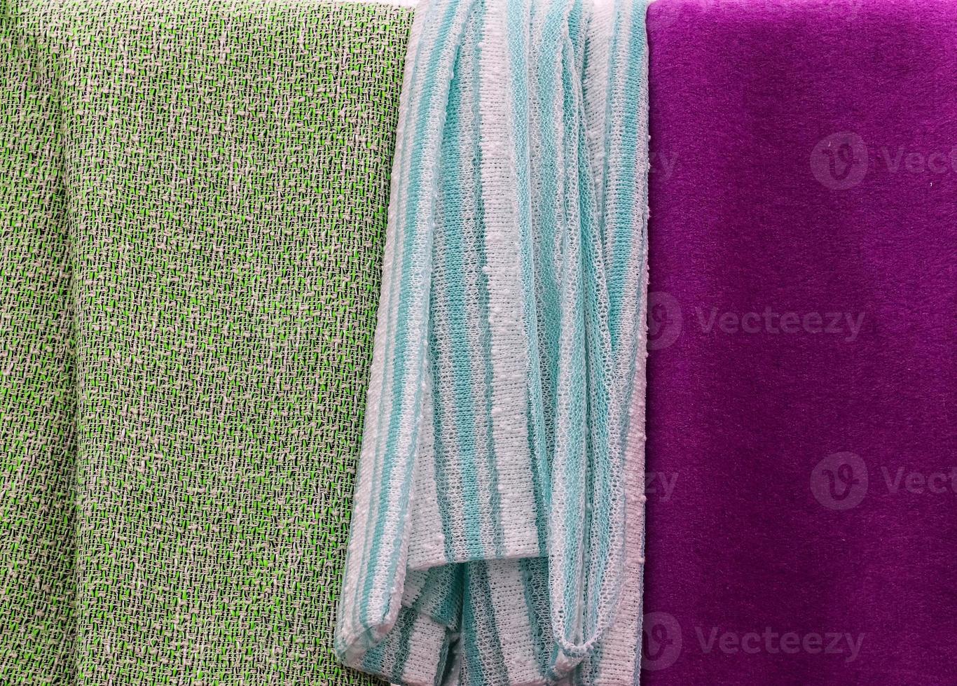 Detailed close up view on samples of cloth and fabrics in different colors found at a fabrics market photo