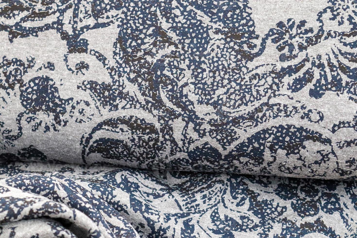 Detailed close up view on samples of cloth and fabrics in different colors found at a fabrics market photo