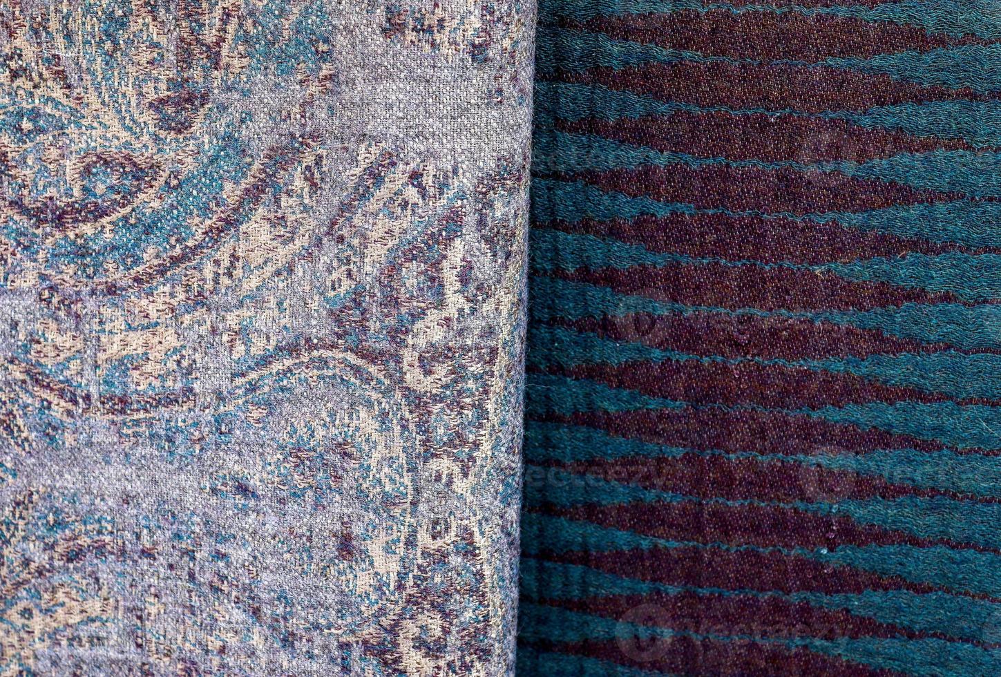 Detailed close up view on samples of cloth and fabrics in different colors found at a fabrics market photo