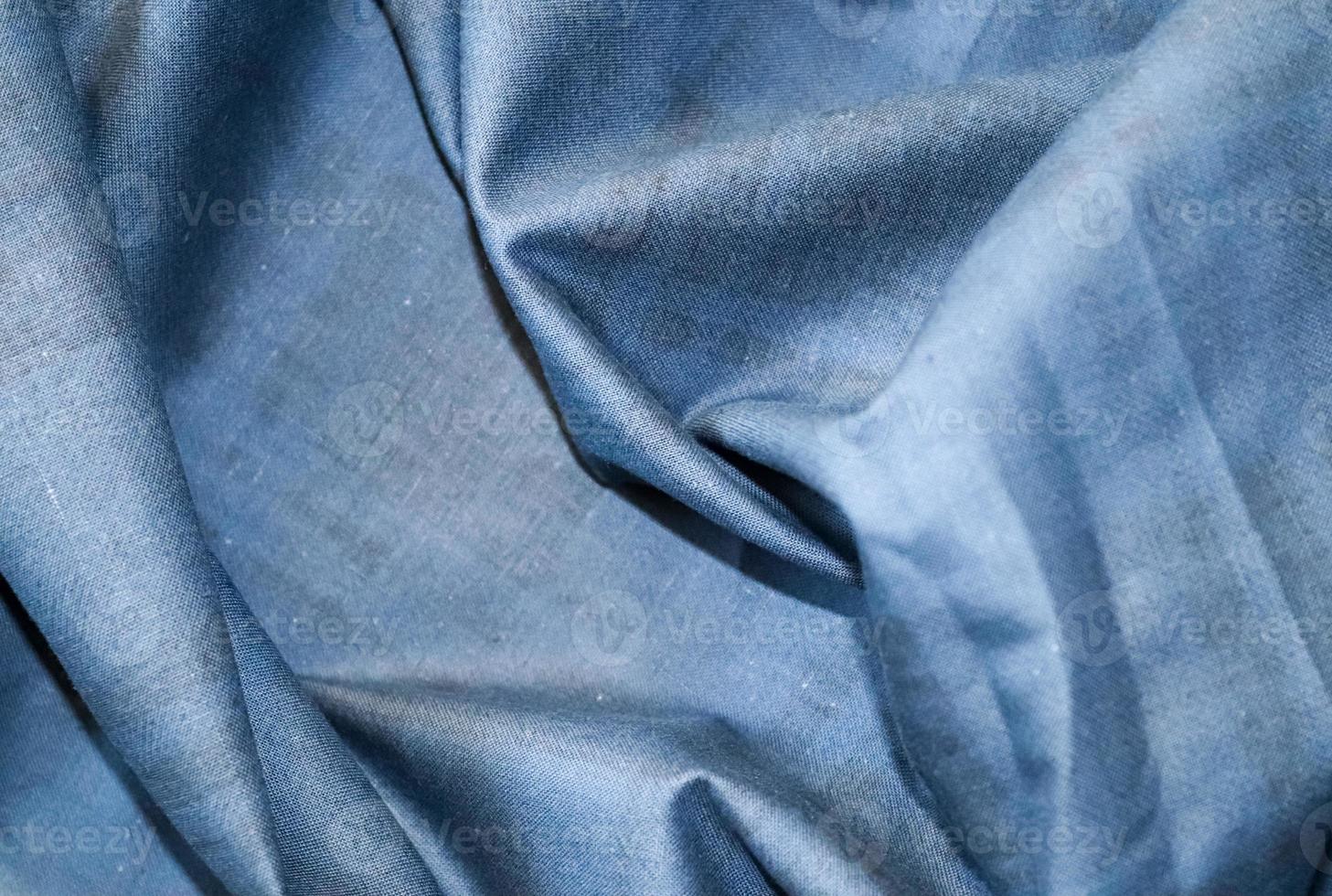 Detailed close up view on samples of cloth and fabrics in different colors found at a fabrics market photo