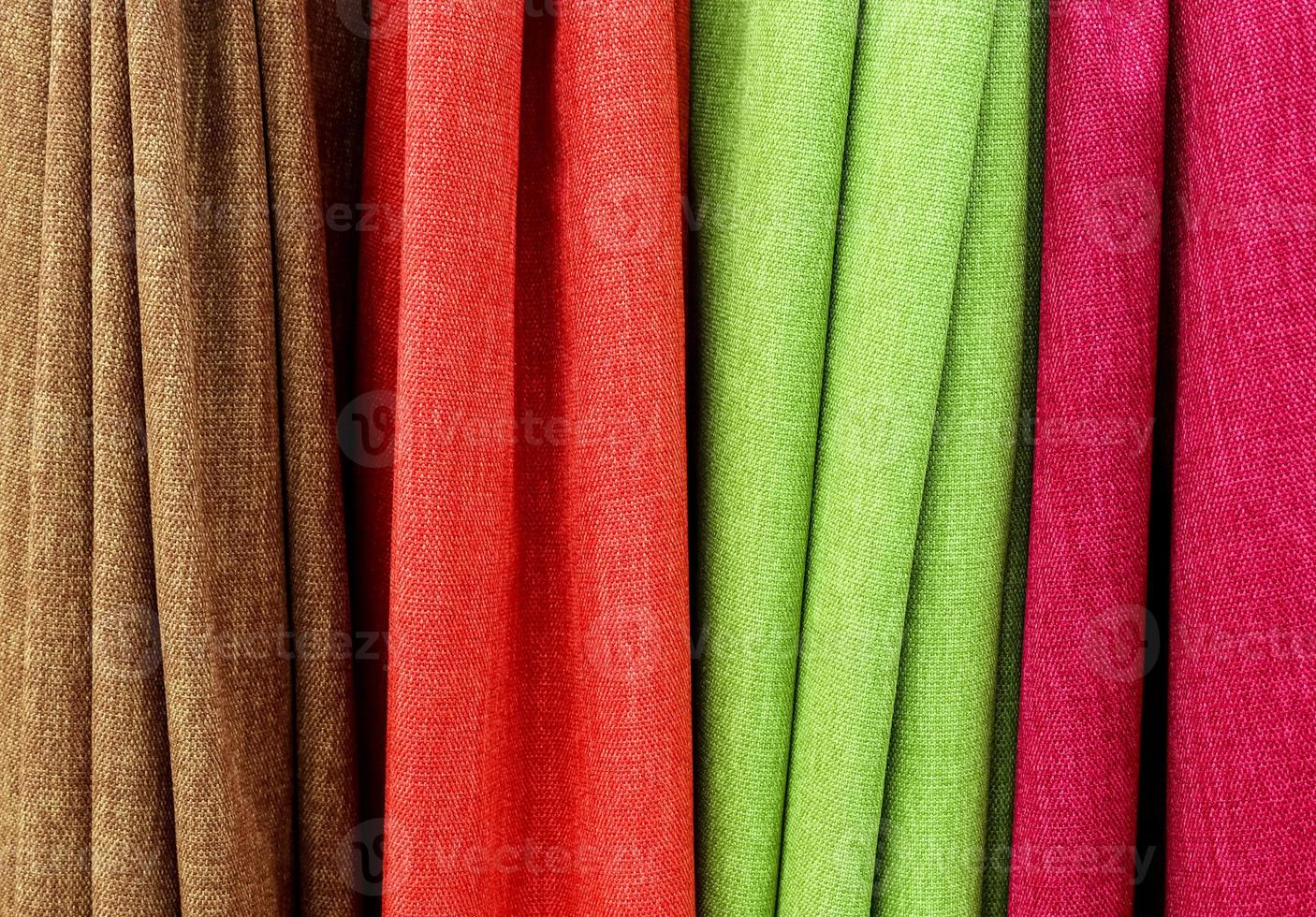 Detailed close up view on samples of cloth and fabrics in different colors found at a fabrics market photo