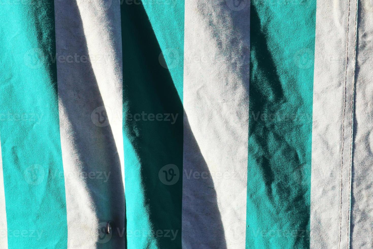 Detailed close up view on samples of cloth and fabrics in different colors found at a fabrics market photo