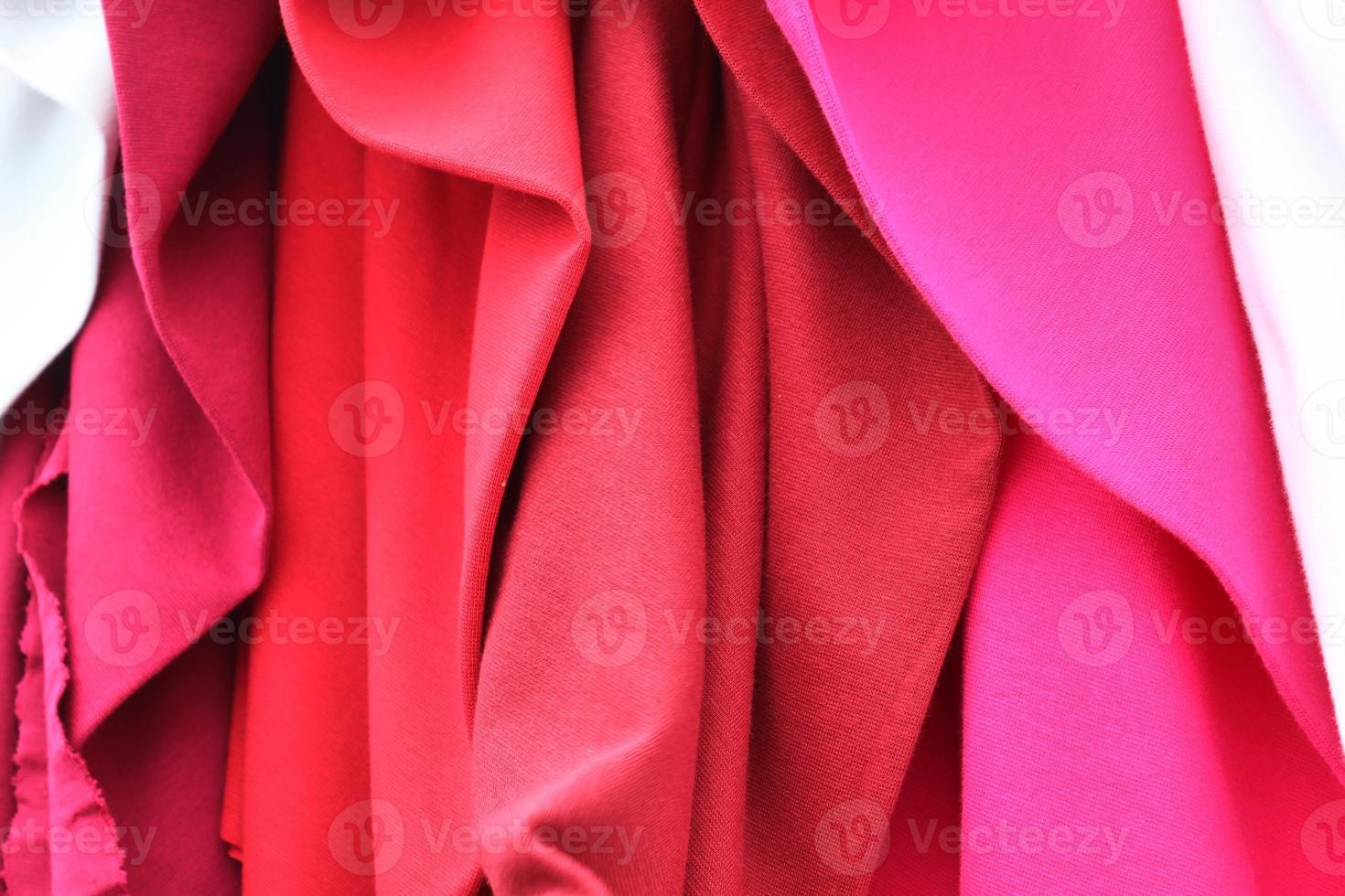Detailed close up view on samples of cloth and fabrics in different colors found at a fabrics market photo
