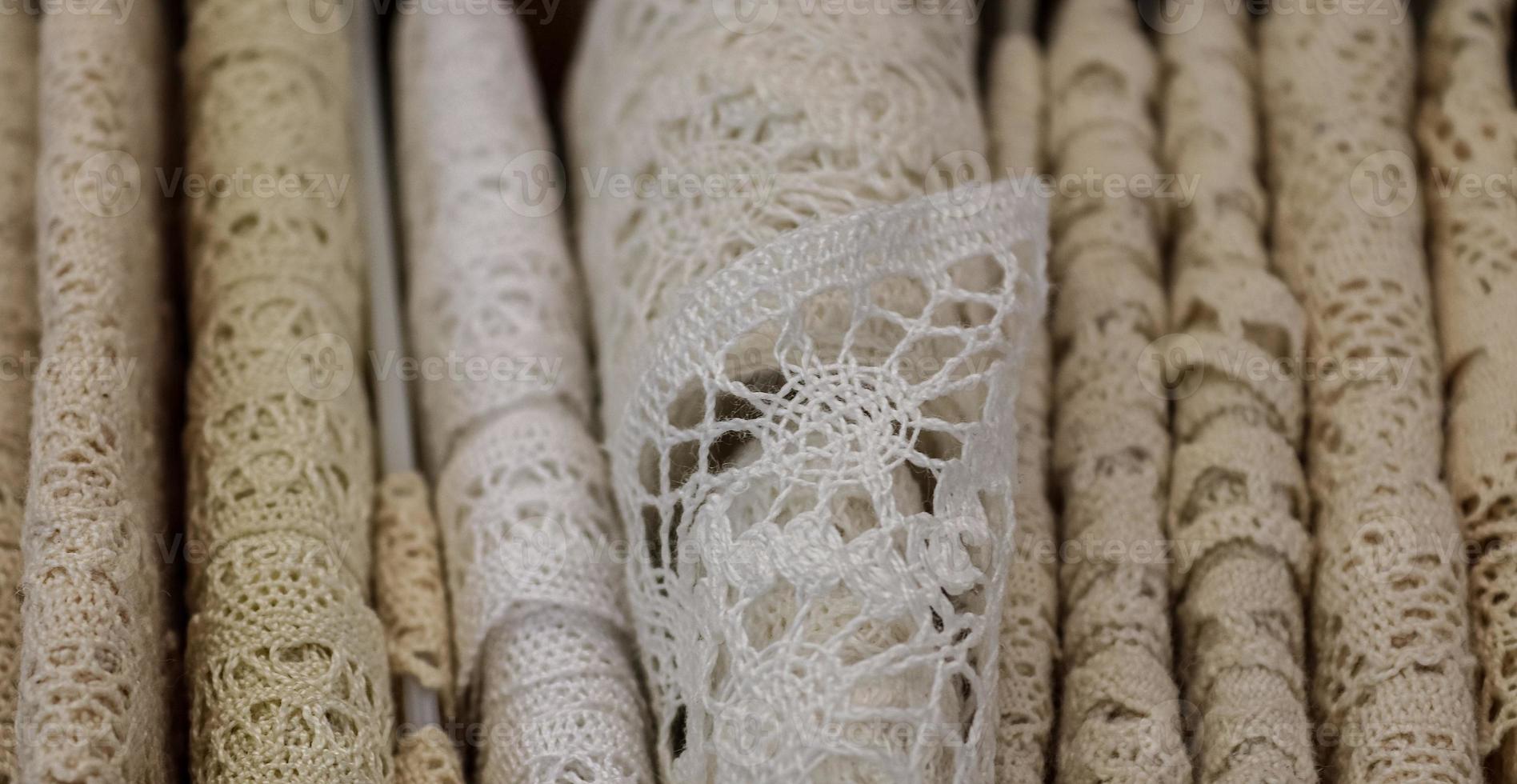 Detailed close up view on samples of cloth and fabrics in different colors found at a fabrics market photo