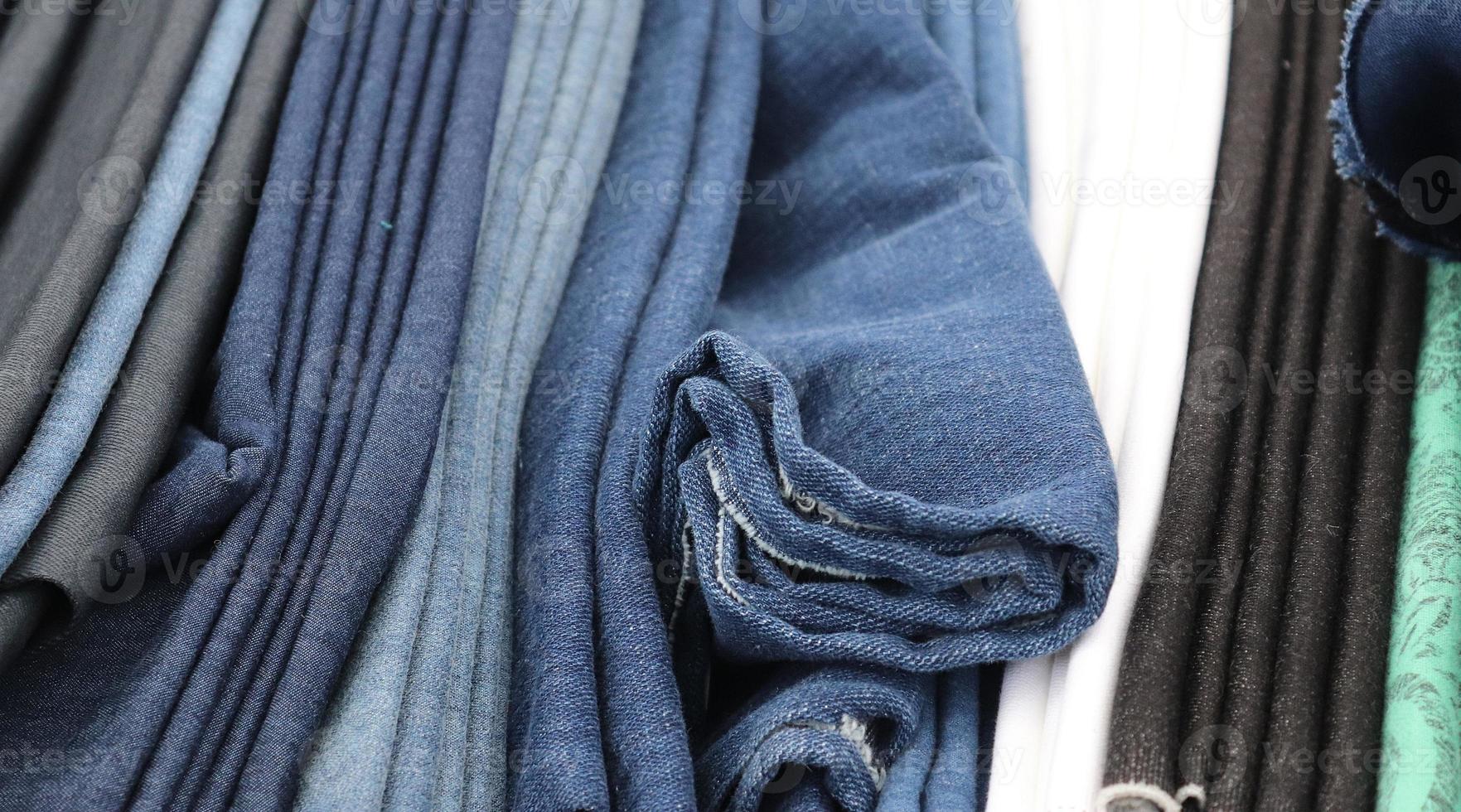 Detailed close up view on samples of cloth and fabrics in different colors found at a fabrics market photo