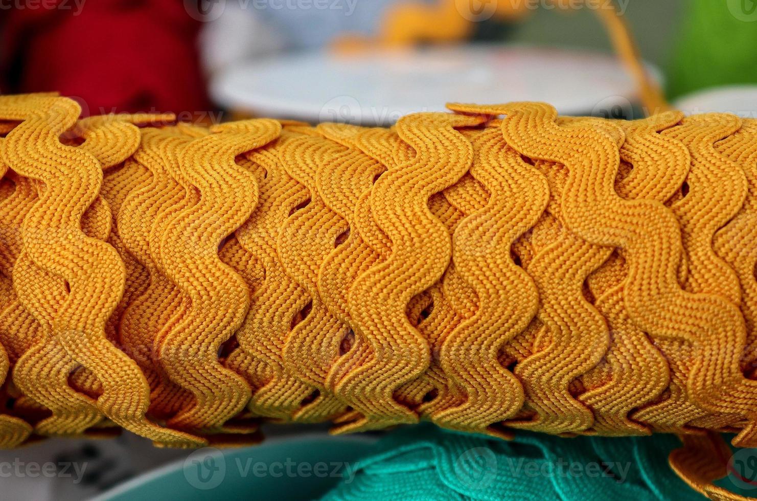 Detailed close up view on samples of cloth and fabrics in different colors found at a fabrics market photo