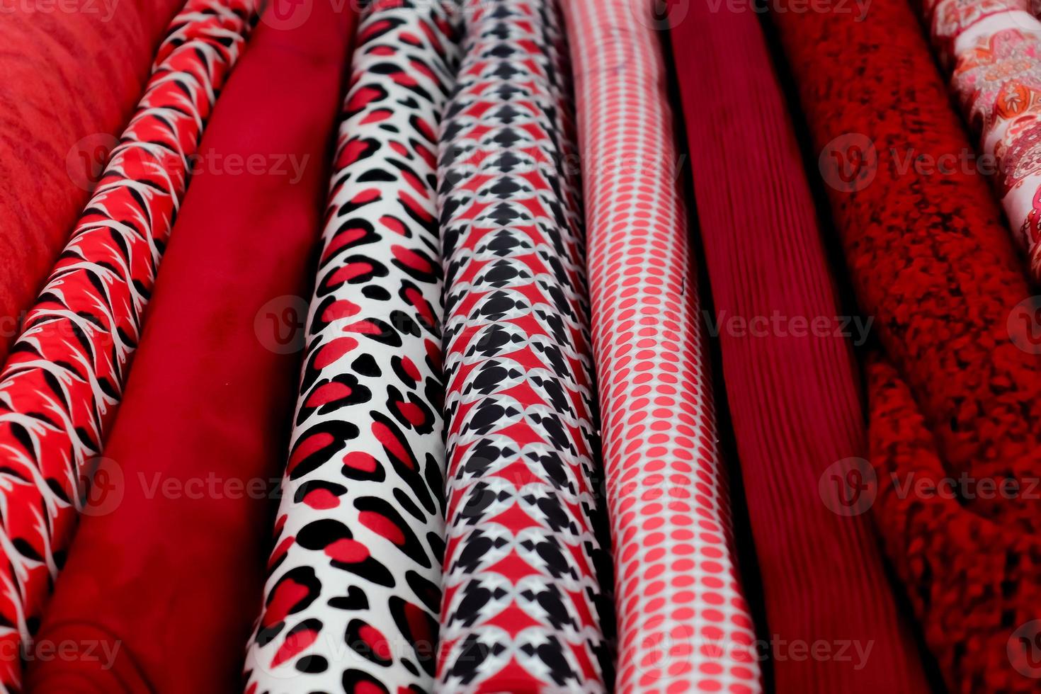 Detailed close up view on samples of cloth and fabrics in different colors found at a fabrics market photo