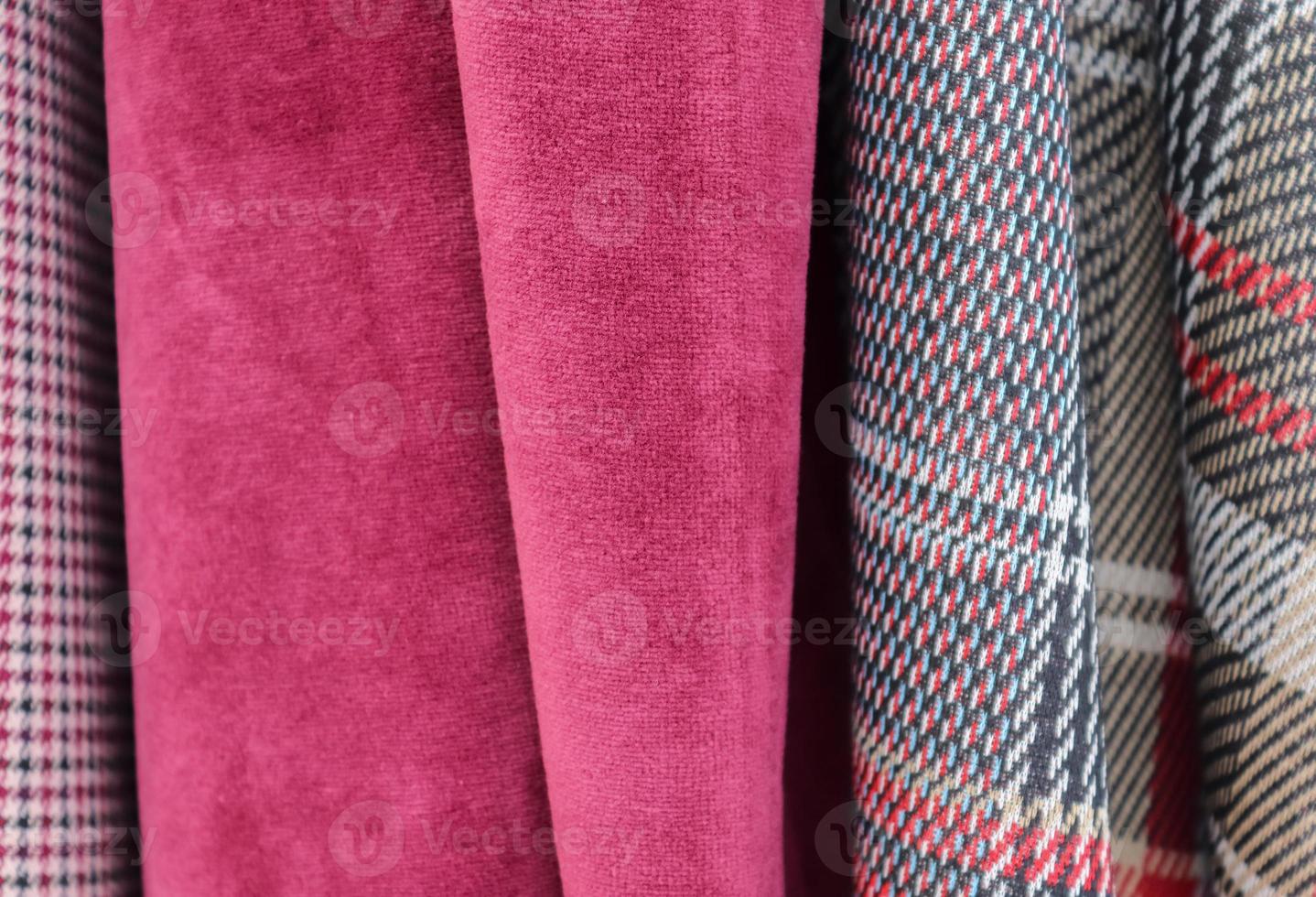 Detailed close up view on samples of cloth and fabrics in different colors found at a fabrics market photo