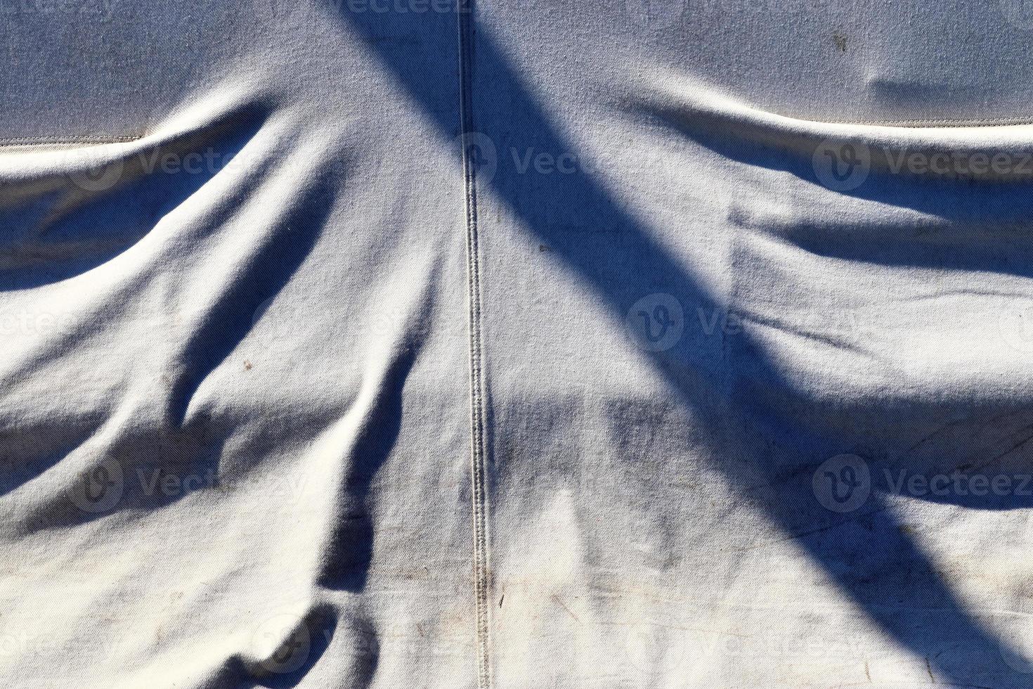 Detailed close up view on samples of cloth and fabrics in different colors found at a fabrics market photo