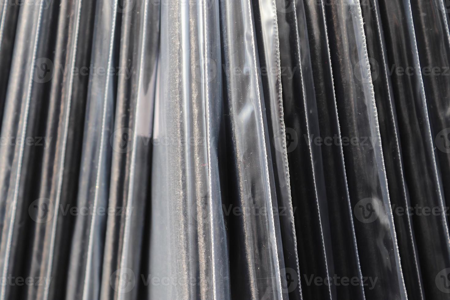 Detailed close up view on samples of cloth and fabrics in different colors found at a fabrics market photo