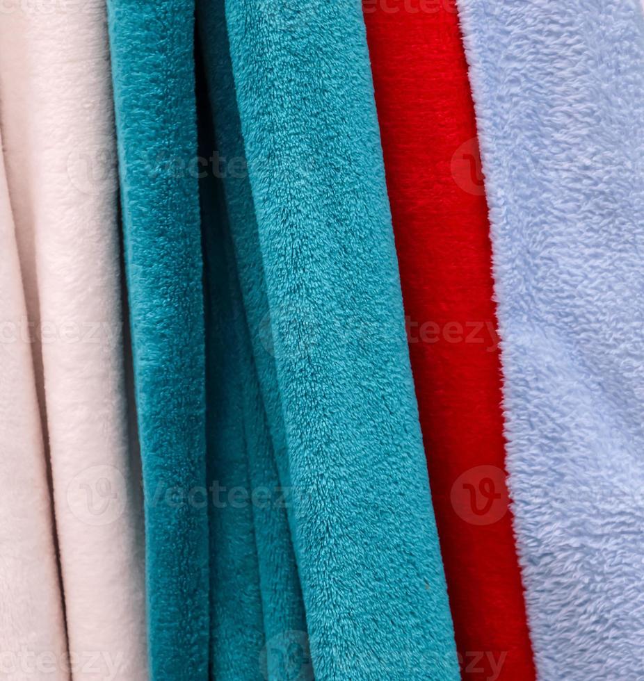 Detailed close up view on samples of cloth and fabrics in different colors found at a fabrics market photo