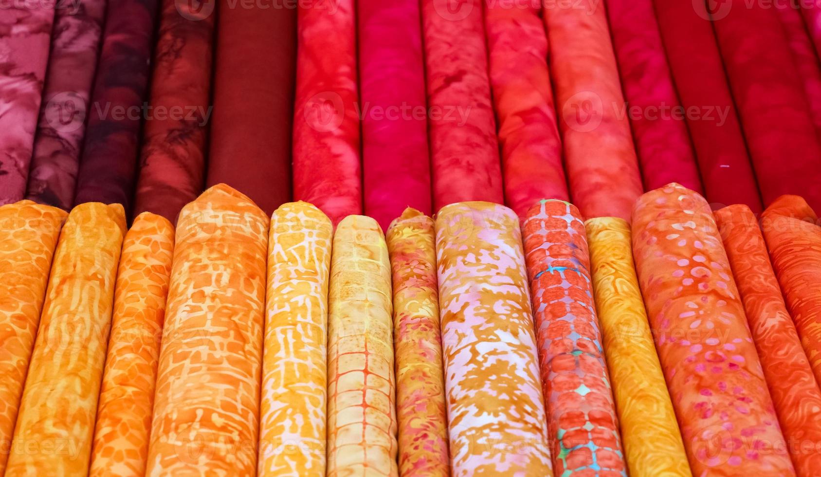 Detailed close up view on samples of cloth and fabrics in different colors found at a fabrics market photo