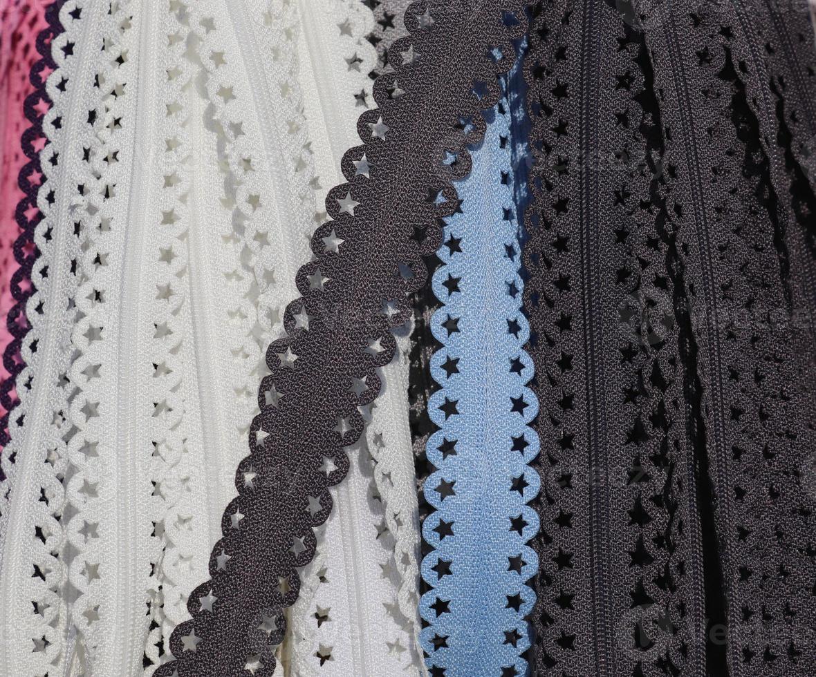 Detailed close up view on samples of cloth and fabrics in different colors found at a fabrics market photo