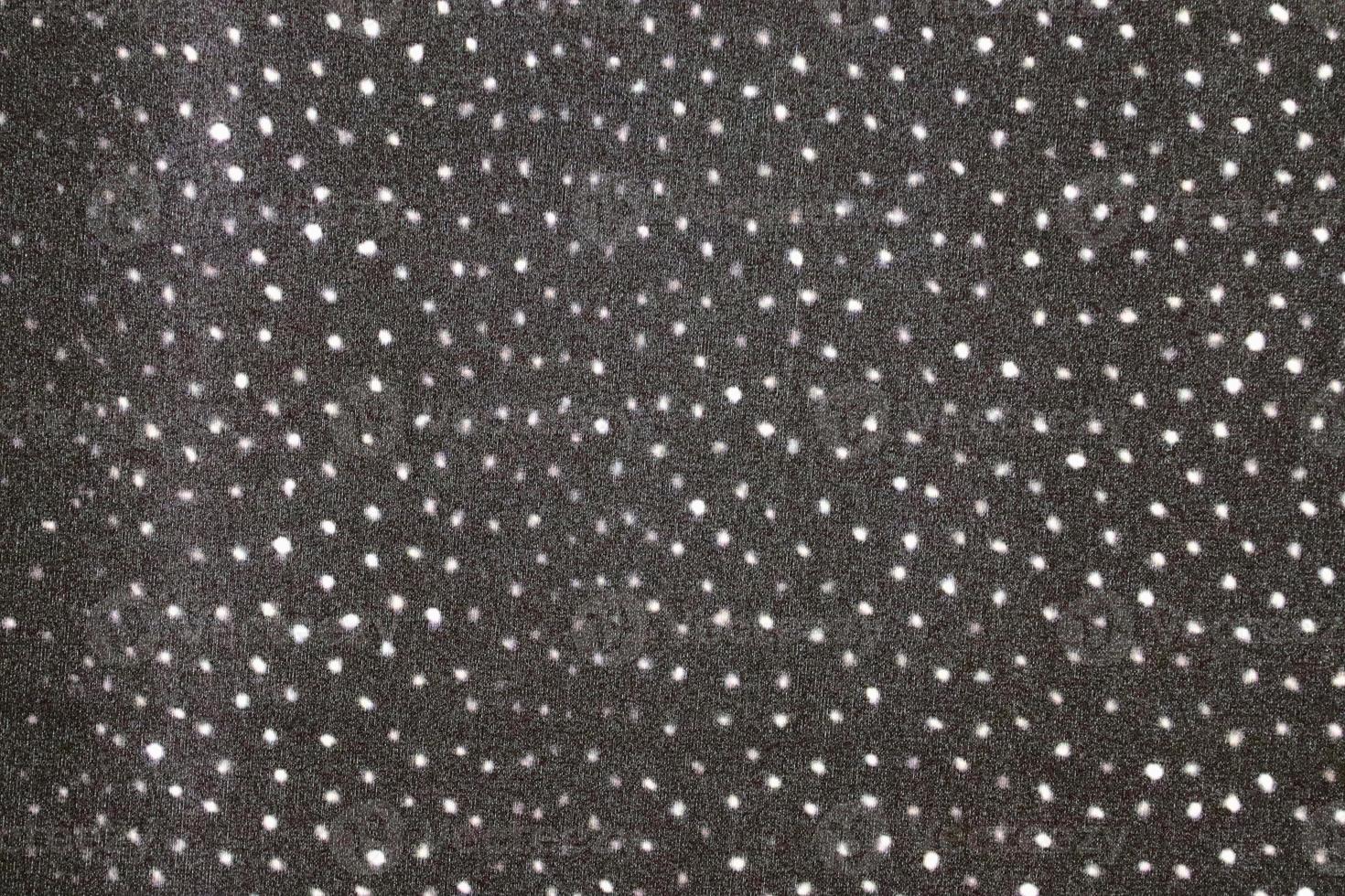 Detailed close up view on samples of cloth and fabrics in different colors found at a fabrics market photo