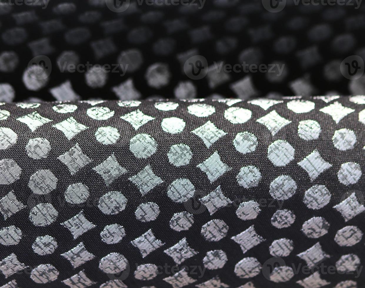 Detailed close up view on samples of cloth and fabrics in different colors found at a fabrics market photo