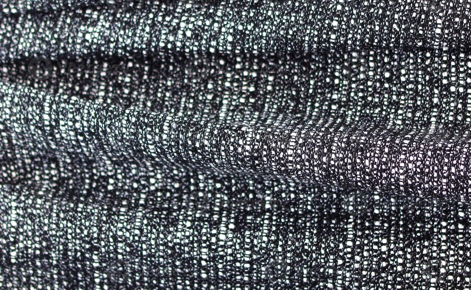 Detailed close up view on samples of cloth and fabrics in different colors found at a fabrics market photo