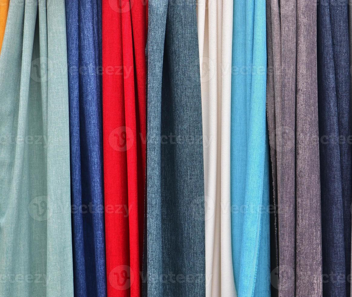 Detailed close up view on samples of cloth and fabrics in different colors found at a fabrics market photo