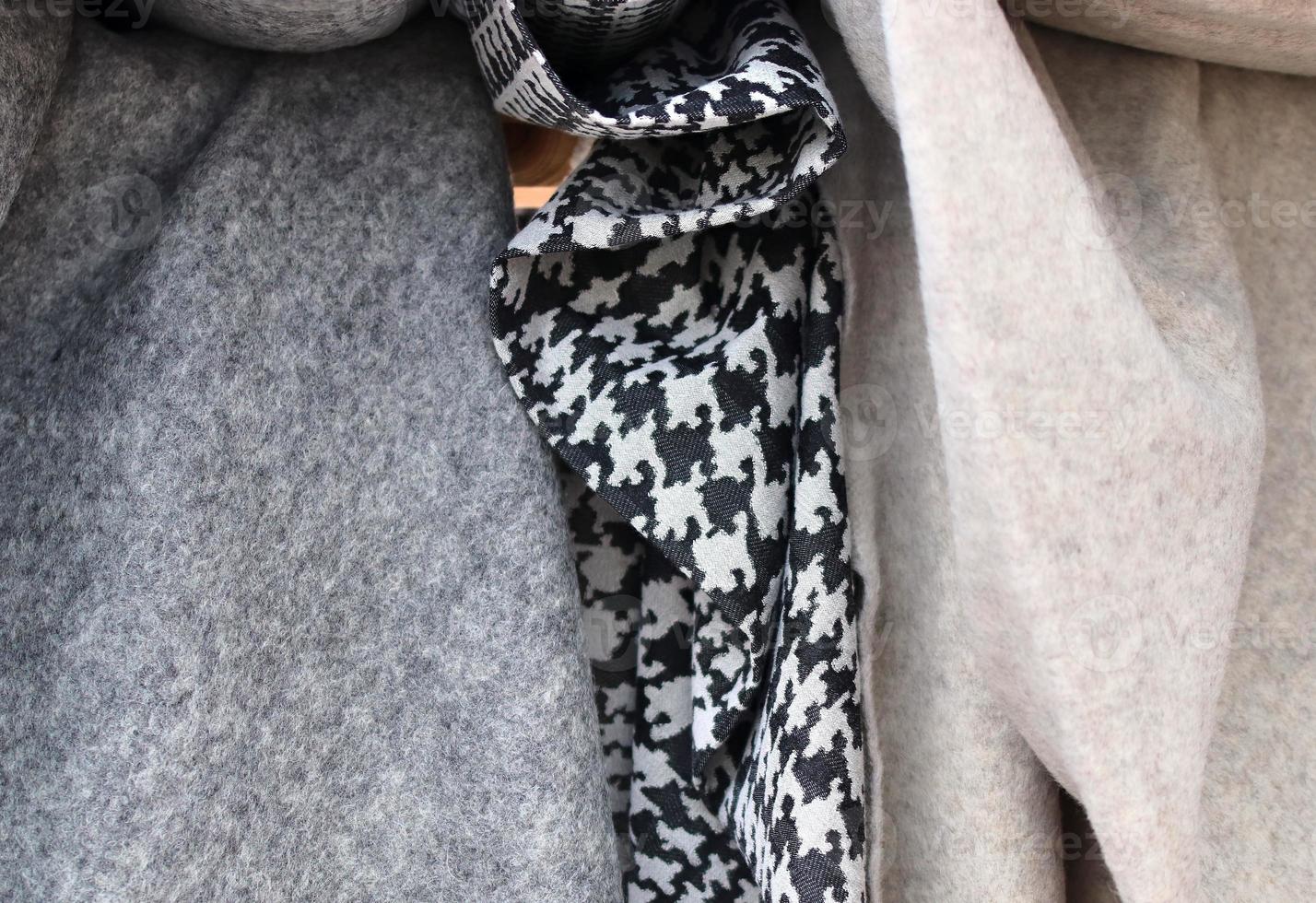 Detailed close up view on samples of cloth and fabrics in different colors found at a fabrics market photo