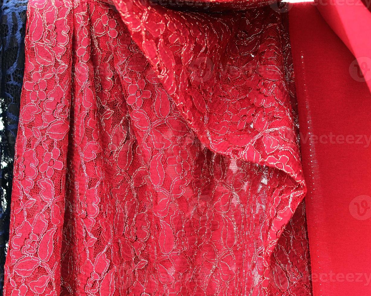 Detailed close up view on samples of cloth and fabrics in different colors found at a fabrics market photo