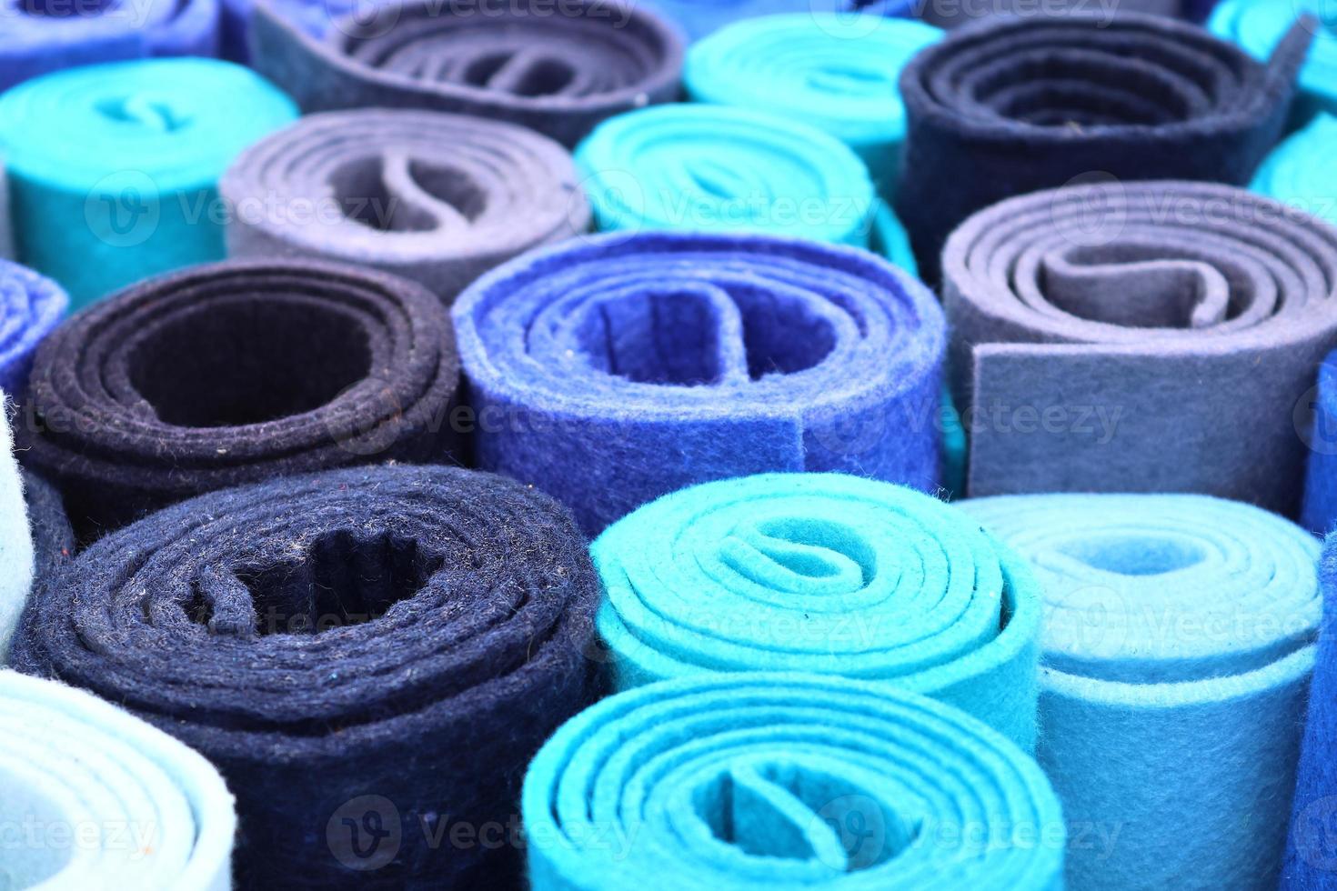 Detailed close up view on samples of cloth and fabrics in different colors found at a fabrics market photo
