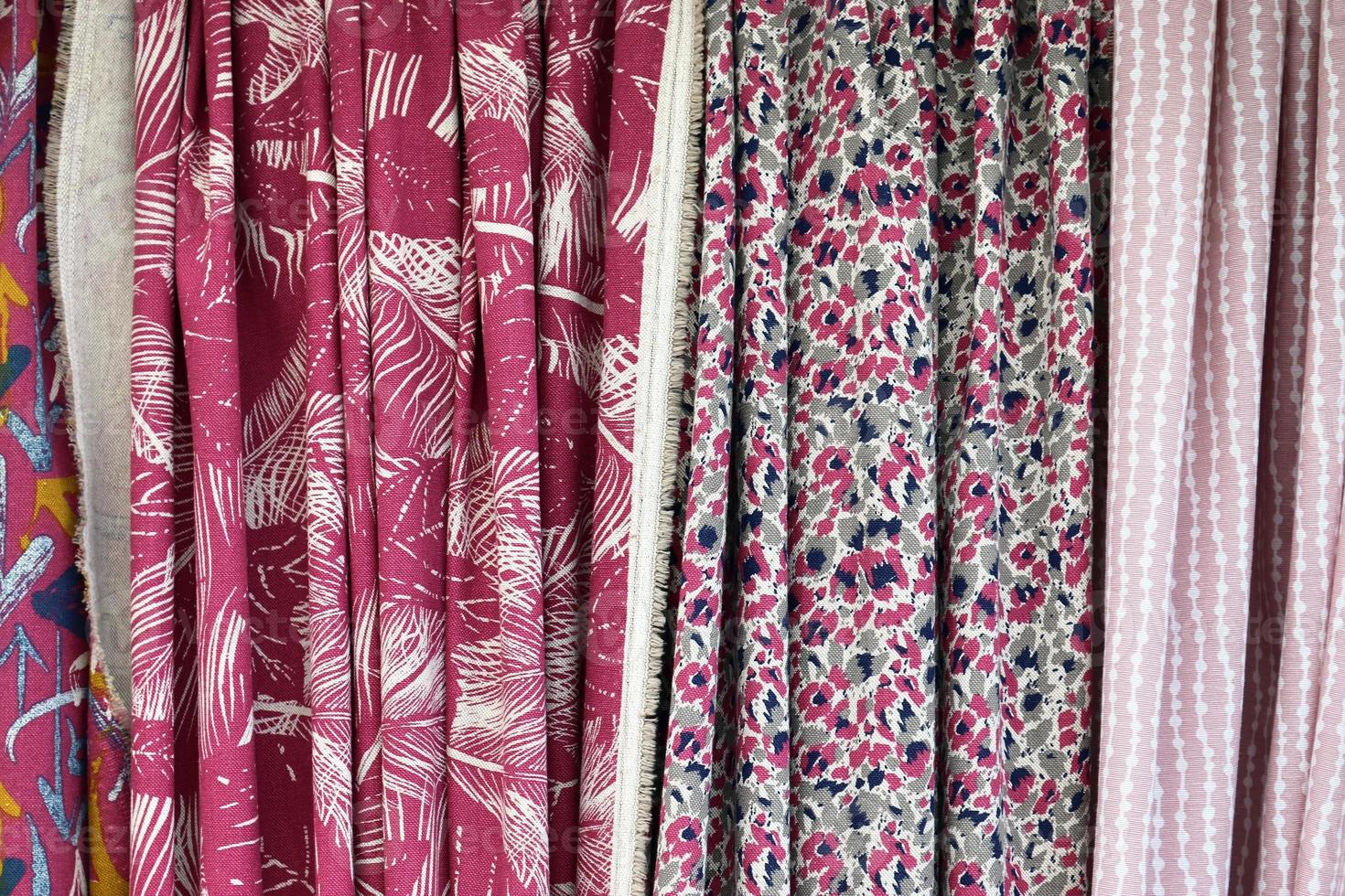 Detailed close up view on samples of cloth and fabrics in different colors found at a fabrics market photo