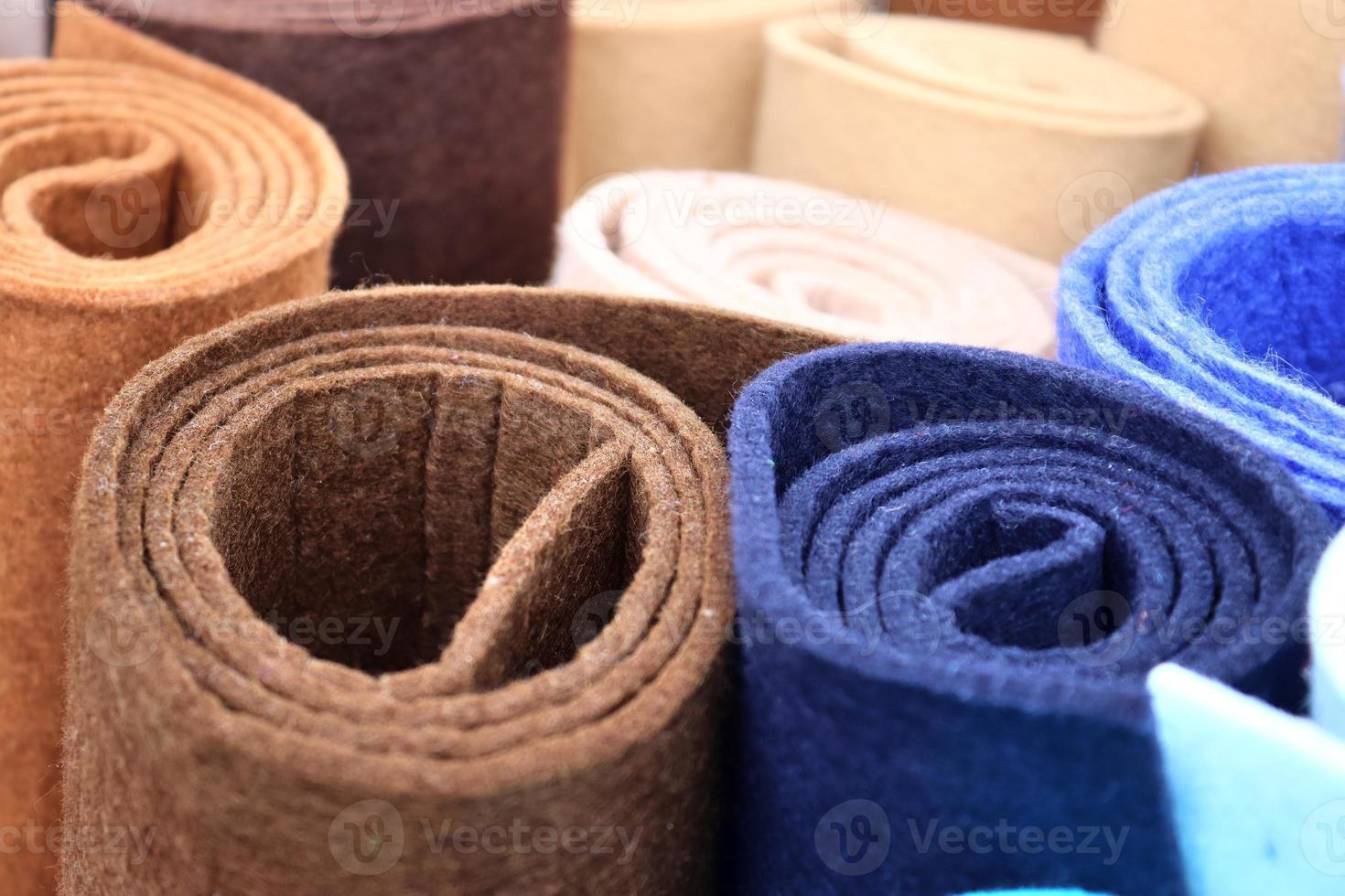 Detailed close up view on samples of cloth and fabrics in different colors found at a fabrics market photo