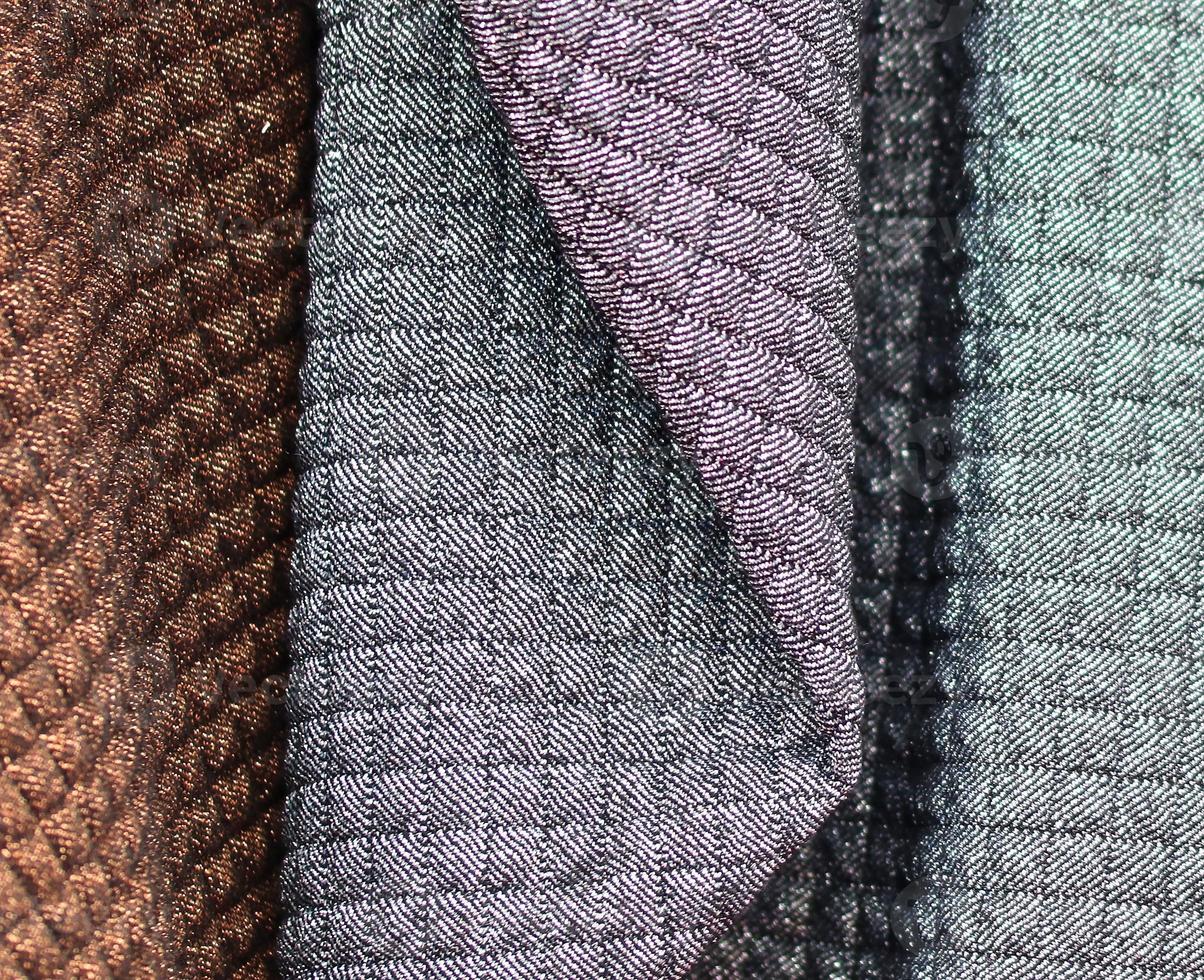 Detailed close up view on samples of cloth and fabrics in different colors found at a fabrics market photo