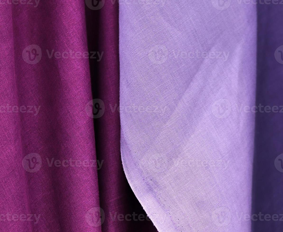 Detailed close up view on samples of cloth and fabrics in different colors found at a fabrics market photo