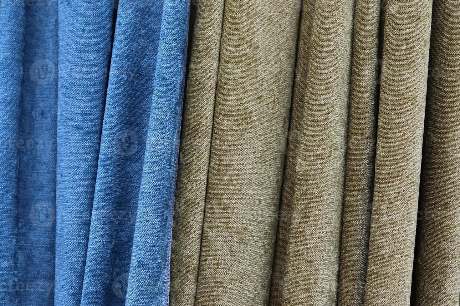 Detailed close up view on samples of cloth and fabrics in different colors found at a fabrics market photo