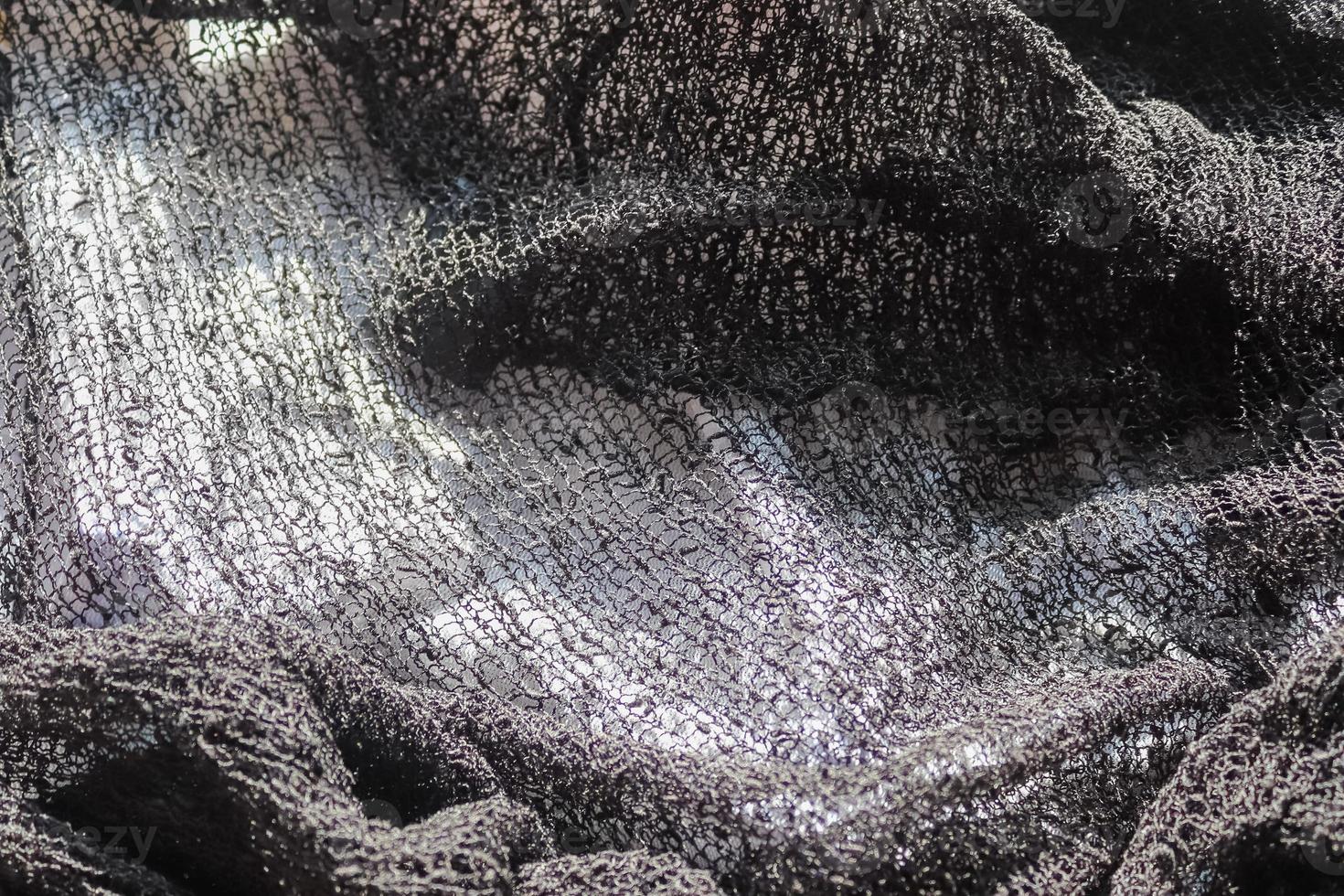 Detailed close up view on samples of cloth and fabrics in different colors found at a fabrics market photo