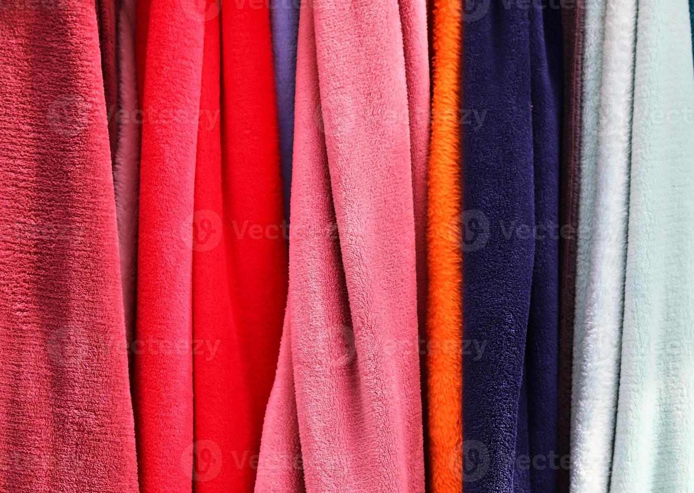 Detailed close up view on samples of cloth and fabrics in different colors found at a fabrics market photo