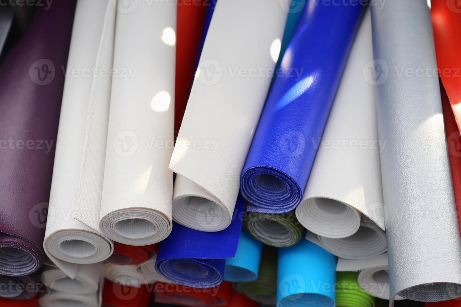 Detailed close up view on samples of cloth and fabrics in different colors found at a fabrics market photo