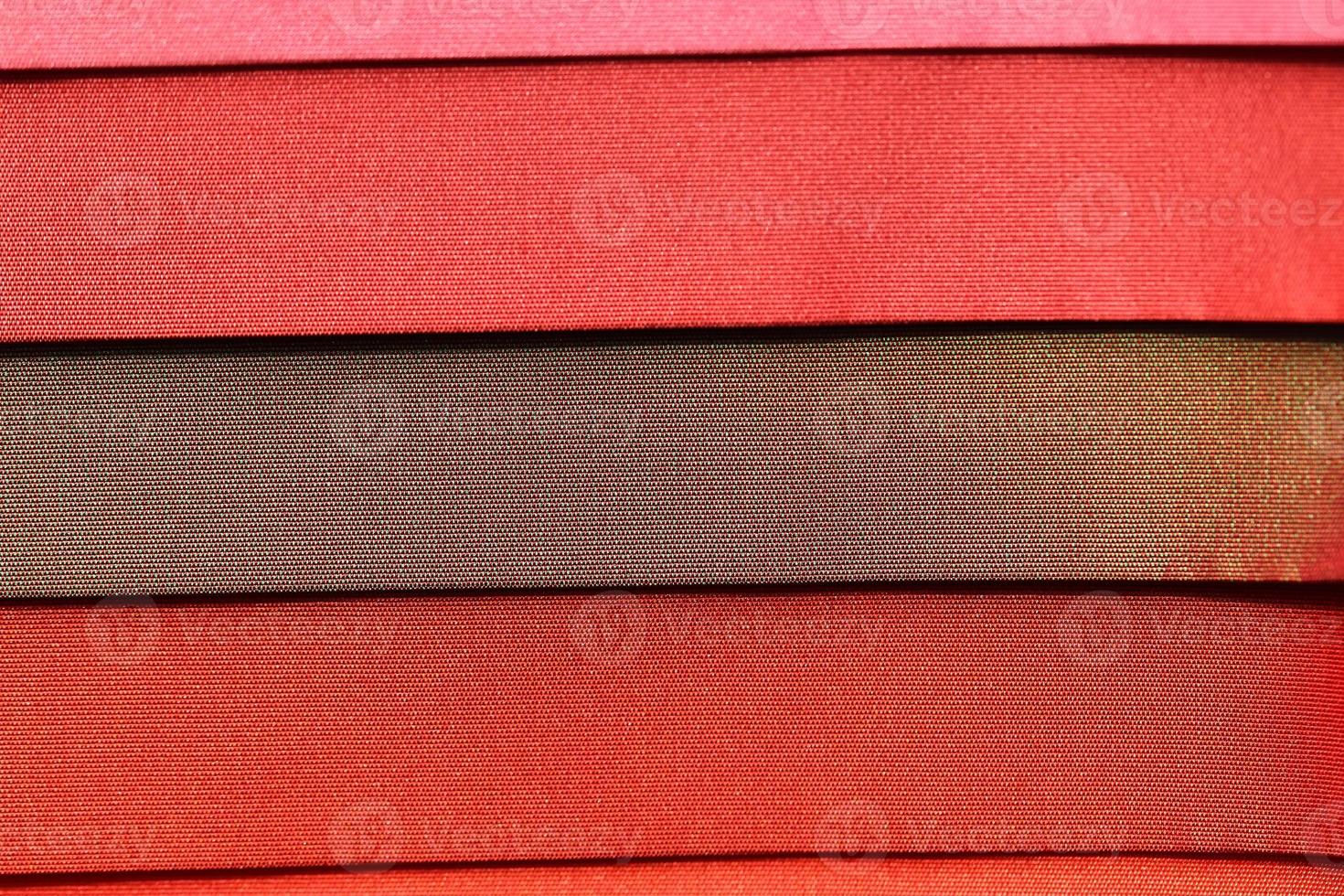 Detailed close up view on samples of cloth and fabrics in different colors found at a fabrics market photo