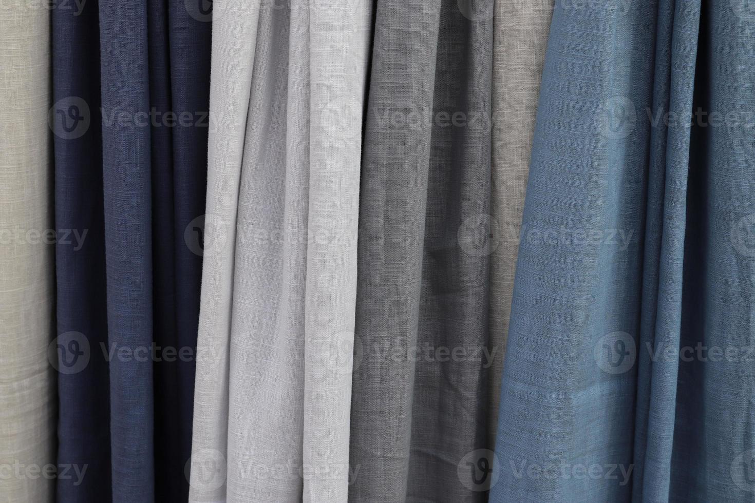 Detailed close up view on samples of cloth and fabrics in different colors found at a fabrics market photo