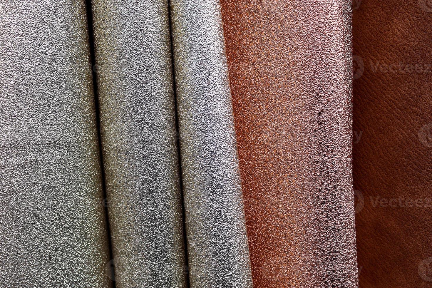 Detailed close up view on samples of cloth and fabrics in different colors found at a fabrics market photo