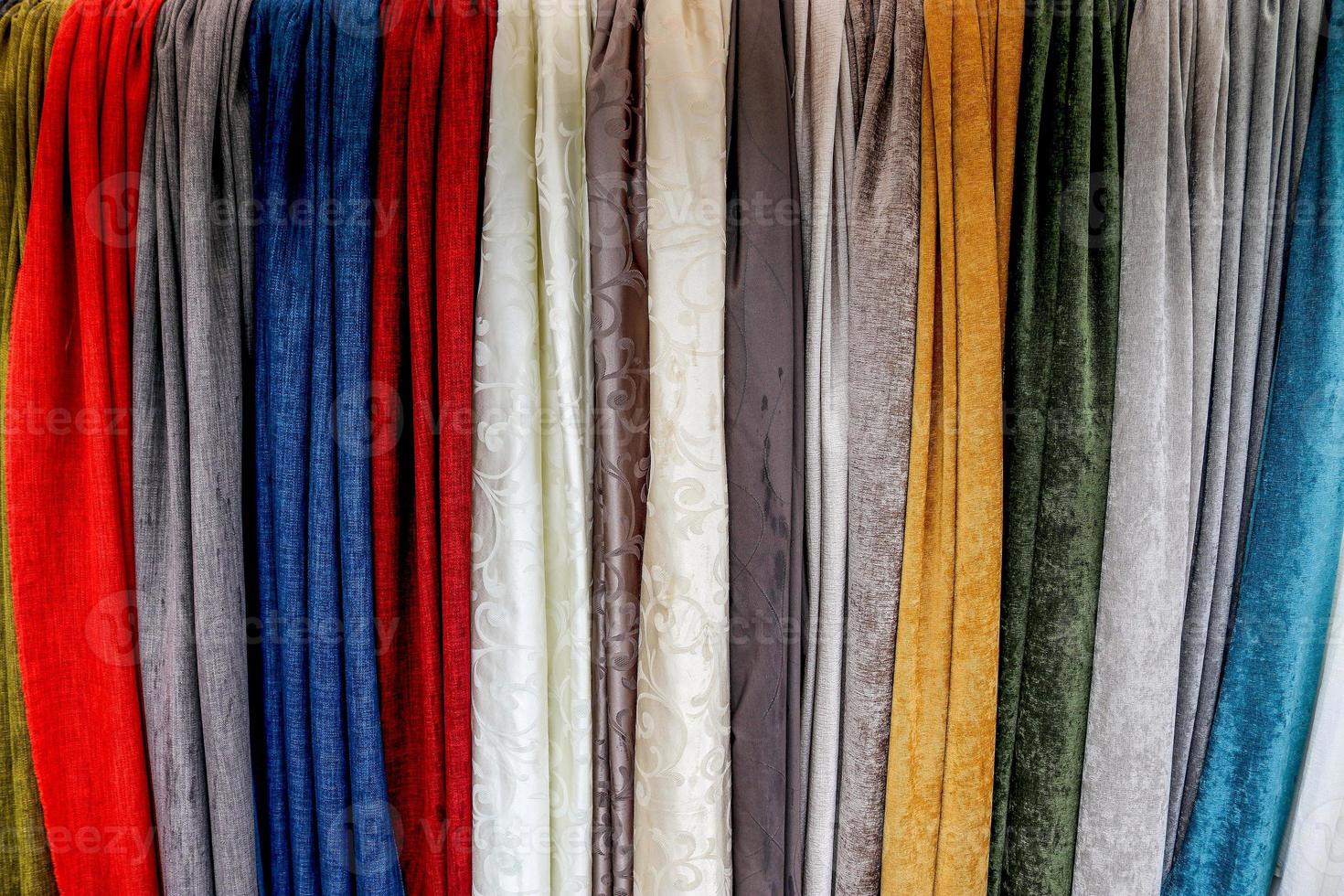 Detailed close up view on samples of cloth and fabrics in different colors found at a fabrics market photo
