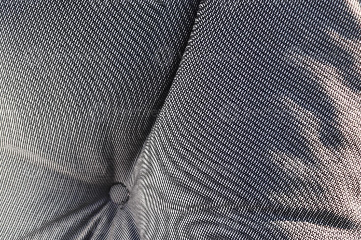 Detailed close up view on samples of cloth and fabrics in different colors found at a fabrics market photo