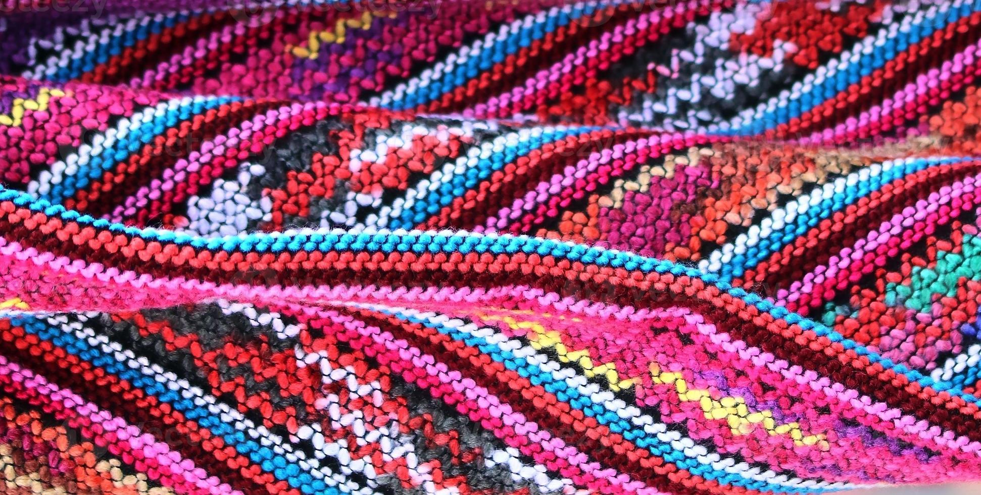 Detailed close up view on samples of cloth and fabrics in different colors found at a fabrics market photo