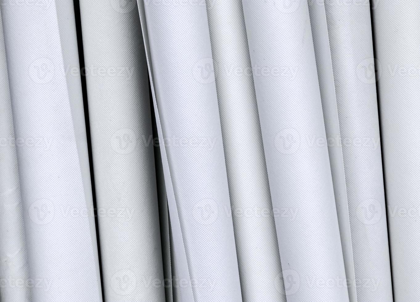 Detailed close up view on samples of cloth and fabrics in different colors found at a fabrics market photo