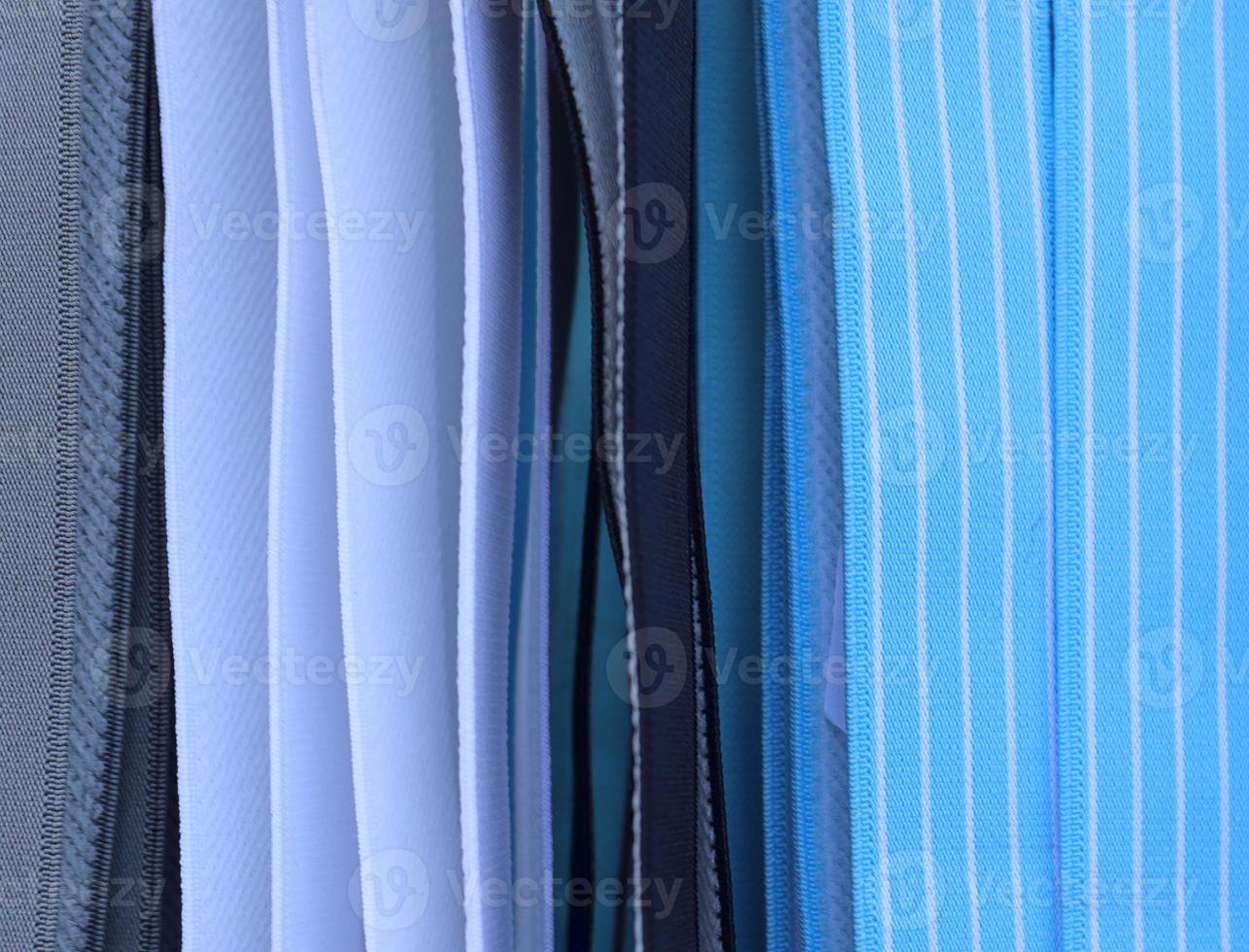 Detailed close up view on samples of cloth and fabrics in different colors found at a fabrics market photo