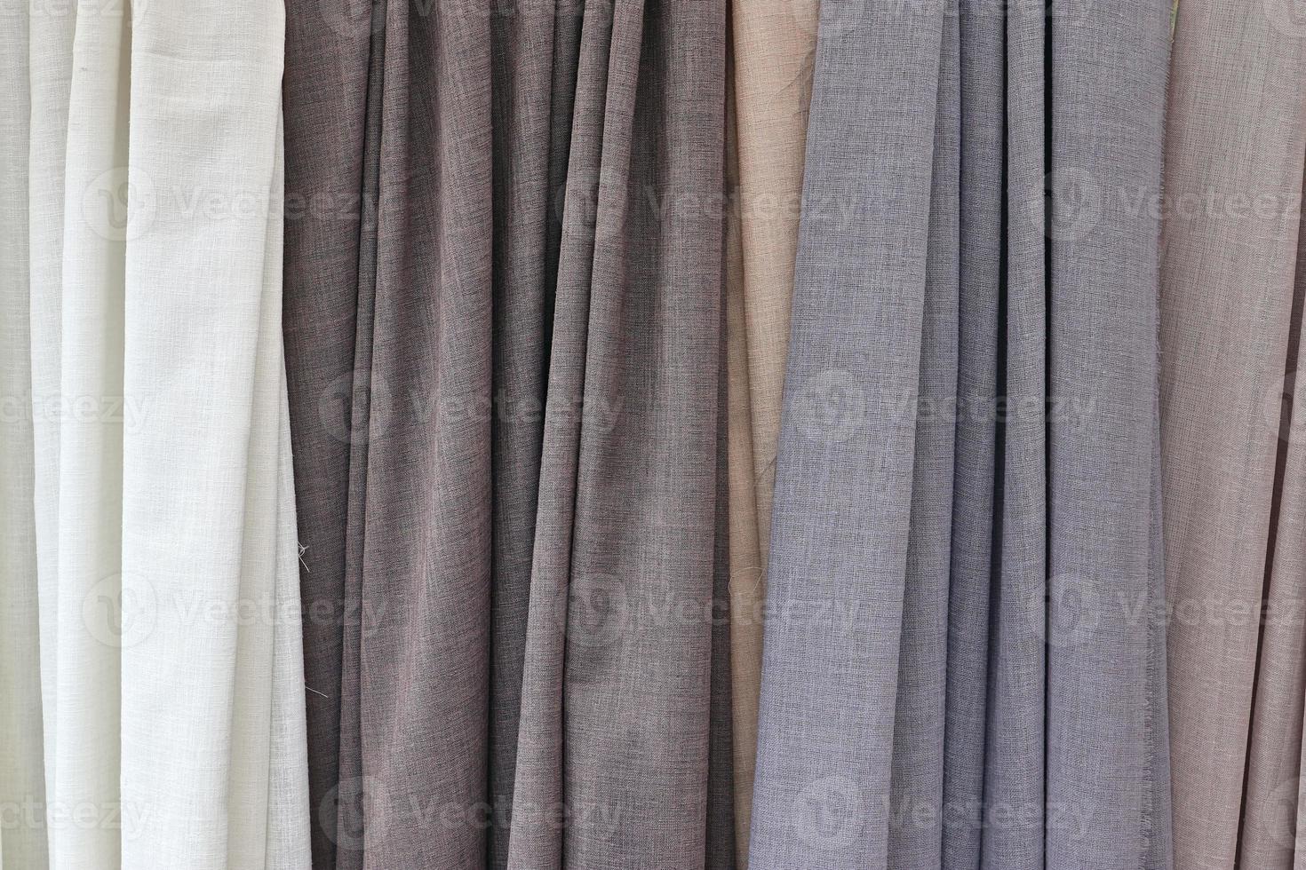 Detailed close up view on samples of cloth and fabrics in different colors found at a fabrics market photo