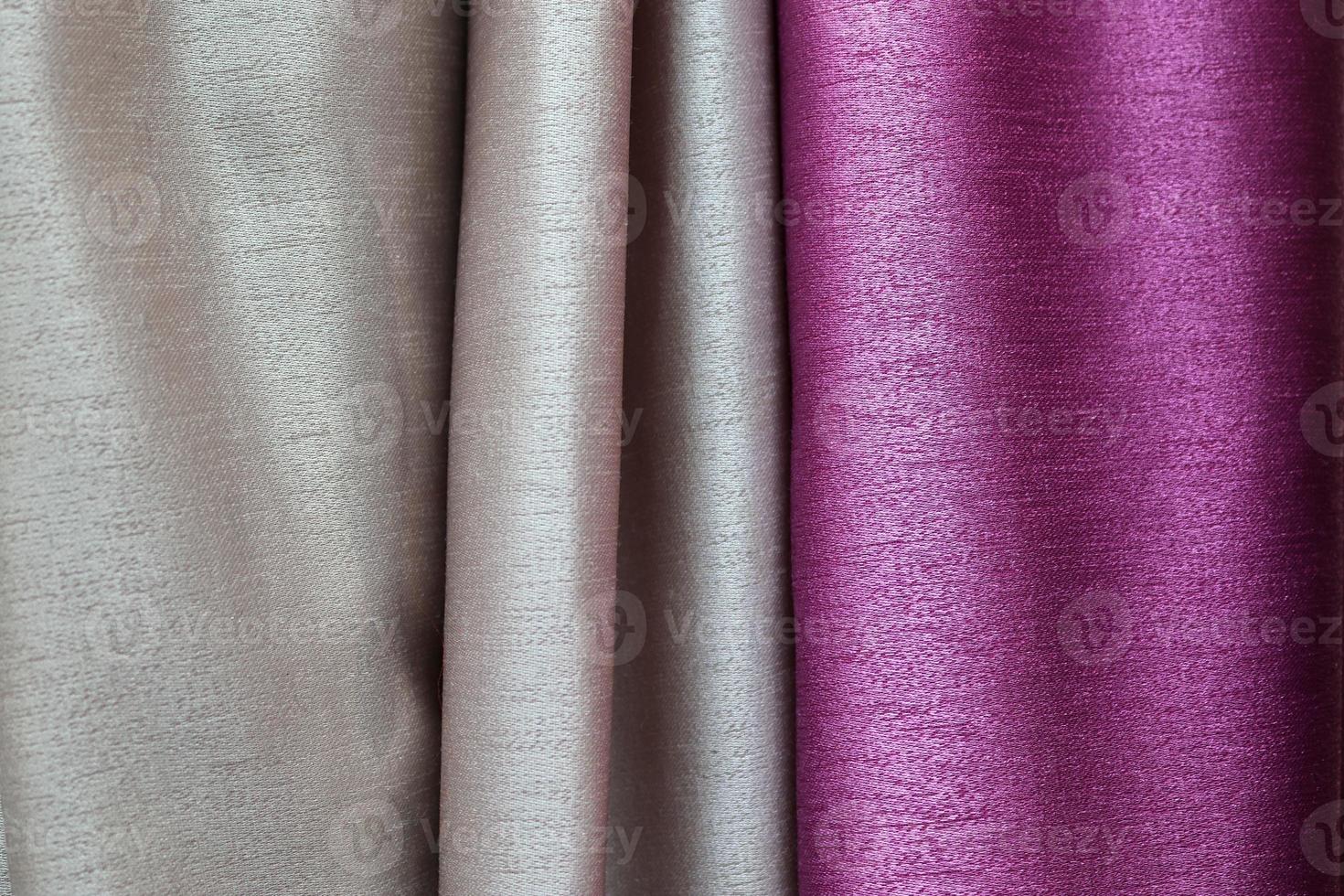 Detailed close up view on samples of cloth and fabrics in different colors found at a fabrics market photo