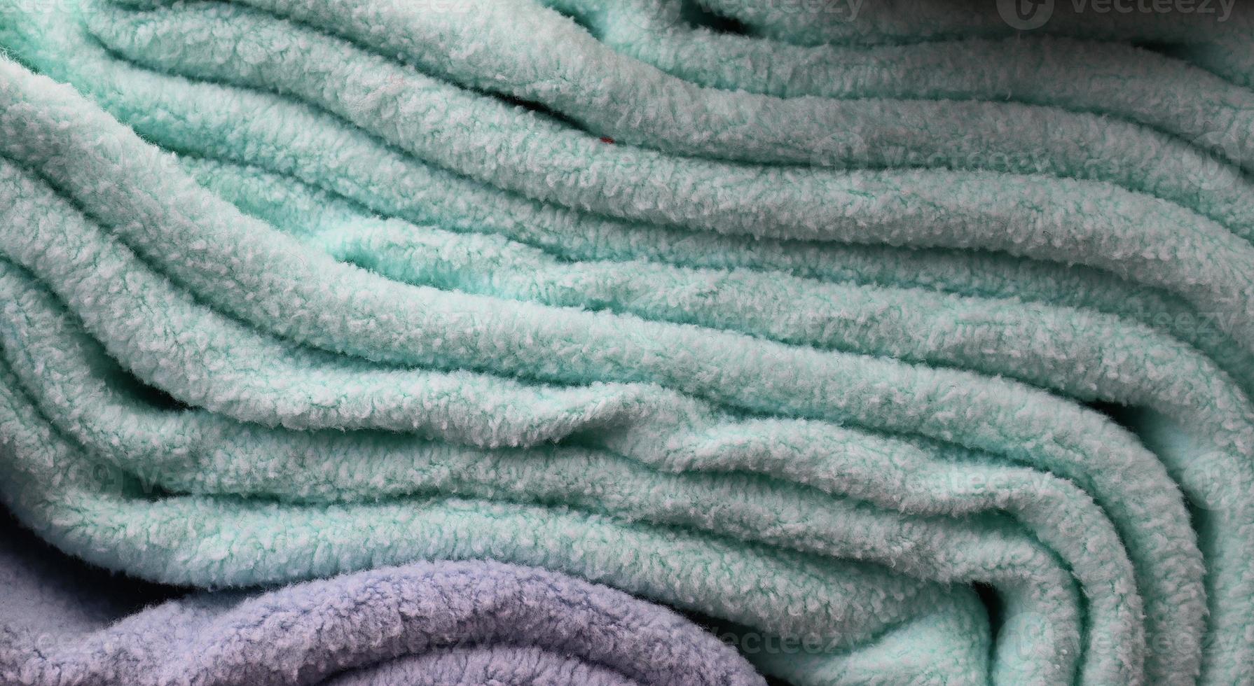 Detailed close up view on samples of cloth and fabrics in different colors found at a fabrics market photo