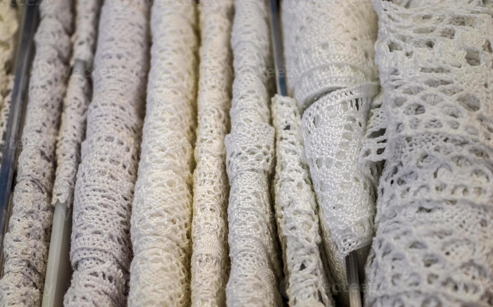 Detailed close up view on samples of cloth and fabrics in different colors found at a fabrics market photo