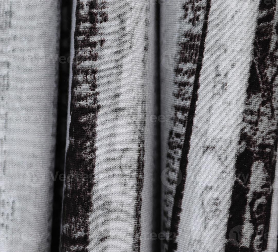 Detailed close up view on samples of cloth and fabrics in different colors found at a fabrics market photo