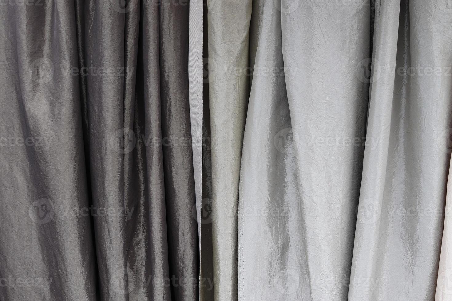 Detailed close up view on samples of cloth and fabrics in different colors found at a fabrics market photo