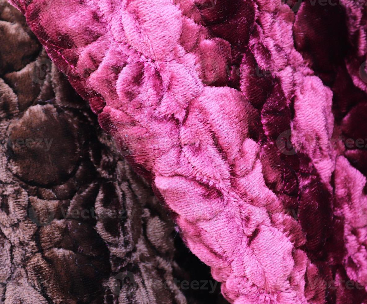 Detailed close up view on samples of cloth and fabrics in different colors found at a fabrics market photo