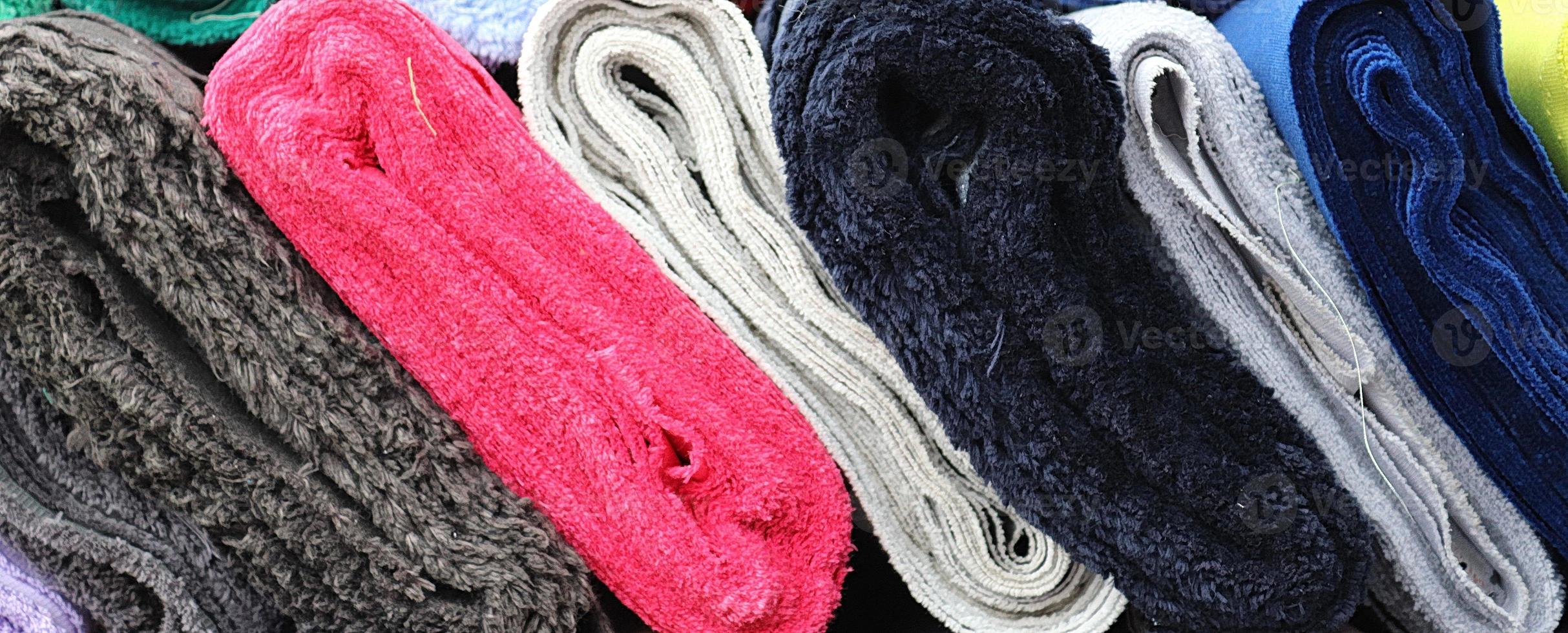 Detailed close up view on samples of cloth and fabrics in different colors found at a fabrics market photo