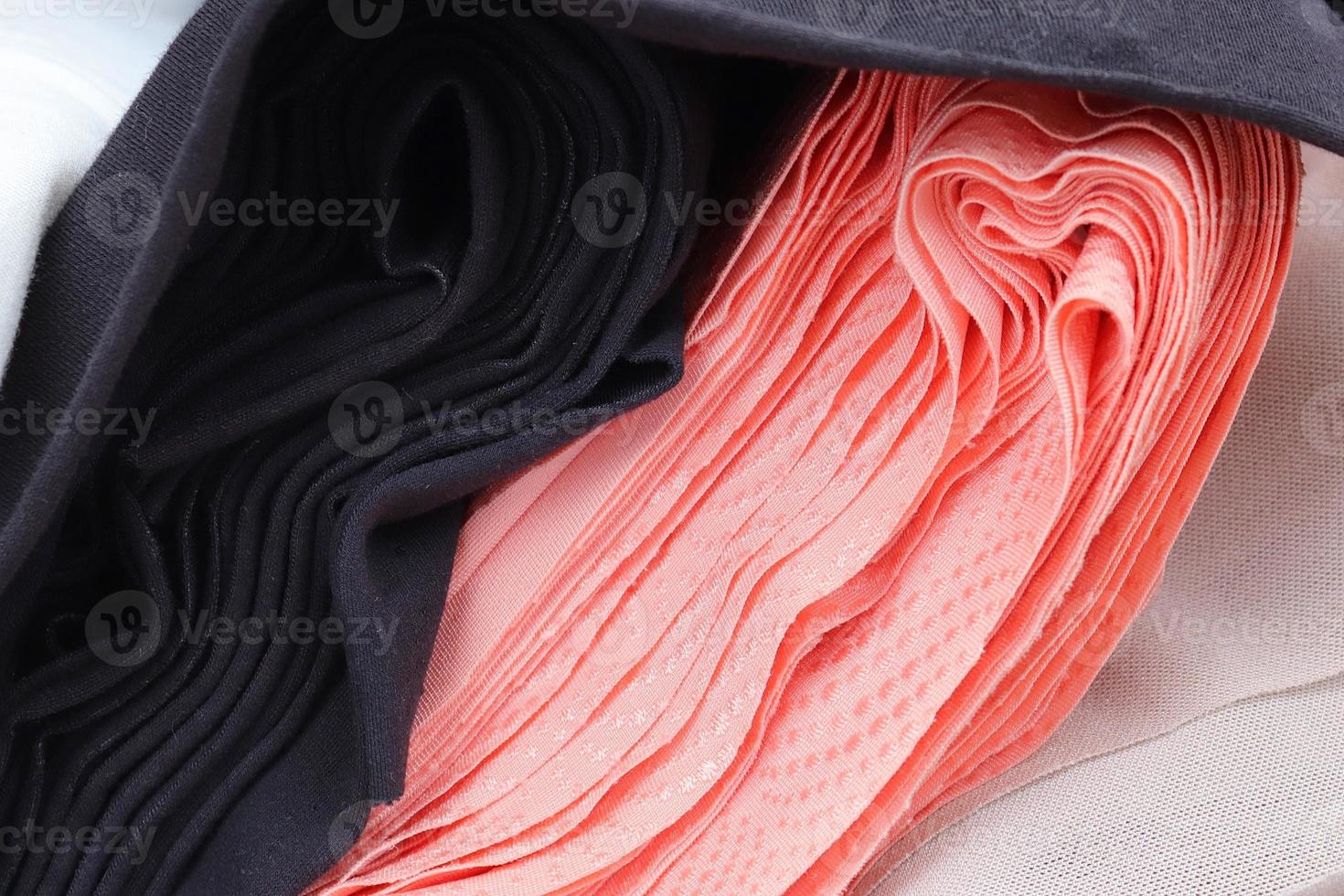 Detailed close up view on samples of cloth and fabrics in different colors found at a fabrics market photo