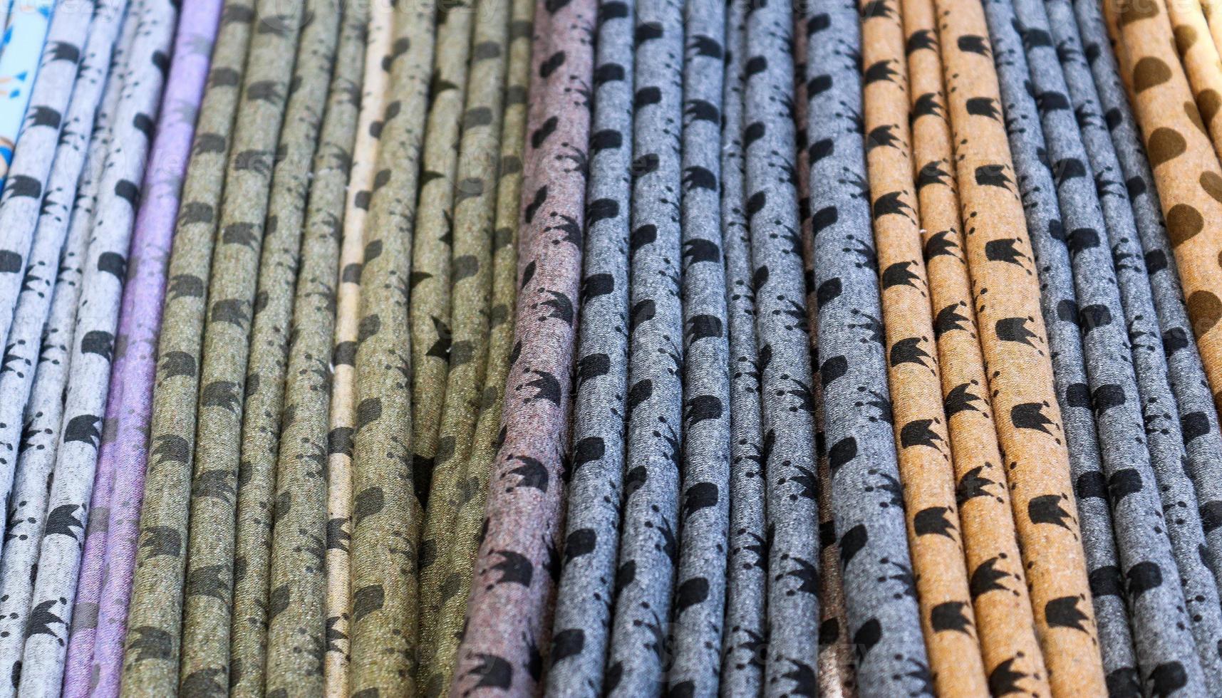 Detailed close up view on samples of cloth and fabrics in different colors found at a fabrics market photo